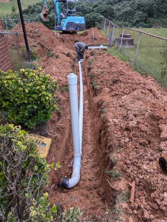 Excavator pipe installation job